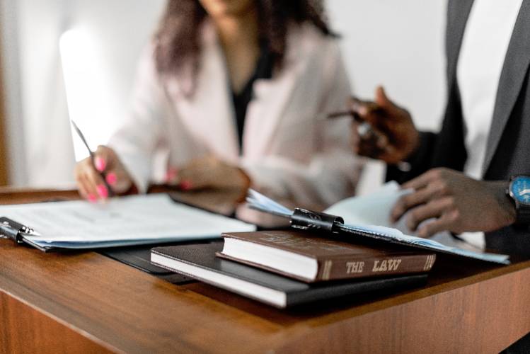 two people reviewing contracts