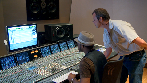 student and instructor in recording studio