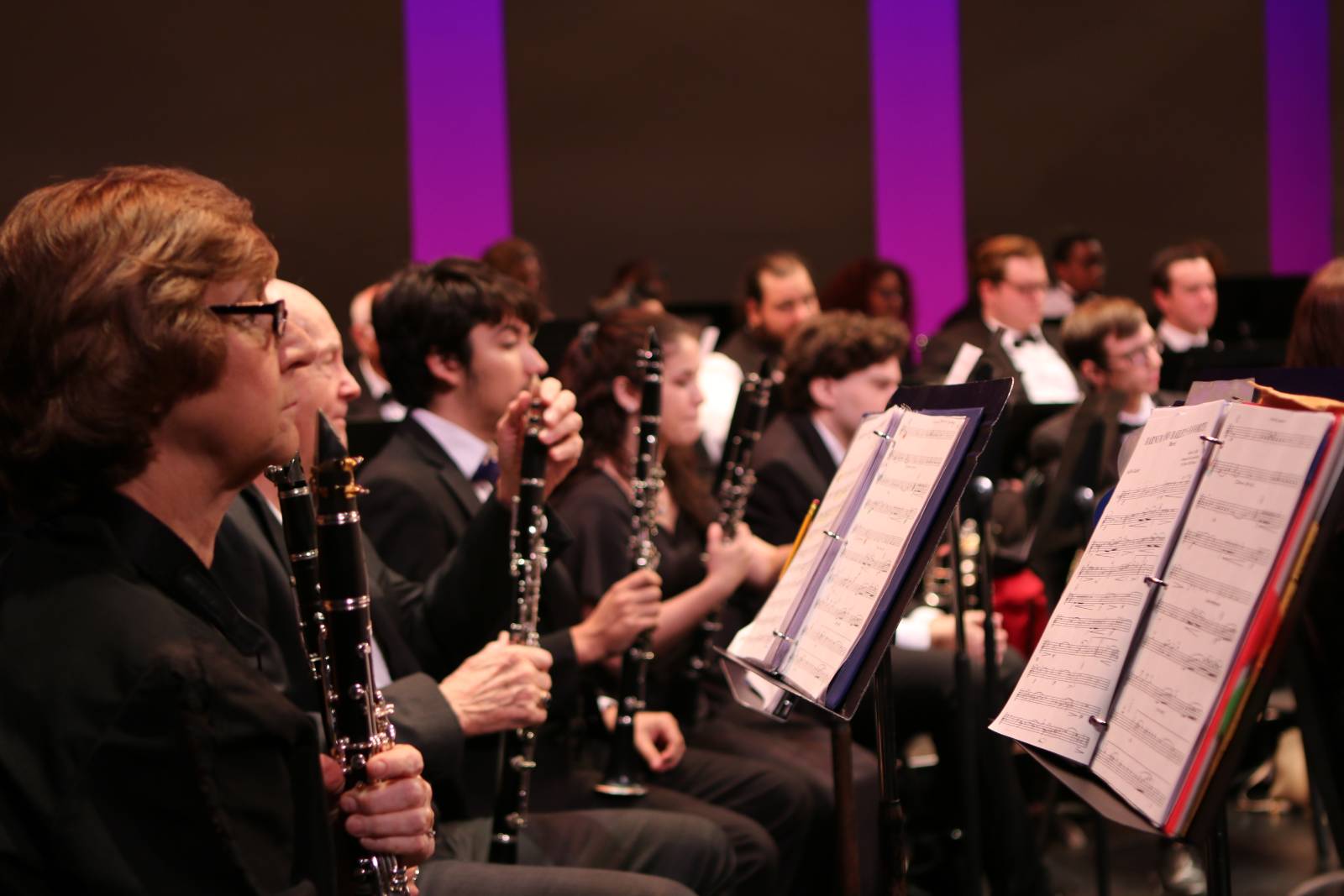 Students playing instruments in the orchestra. 