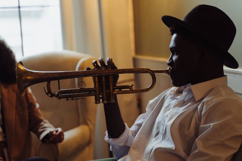 person wearing a hat playing a trumpet