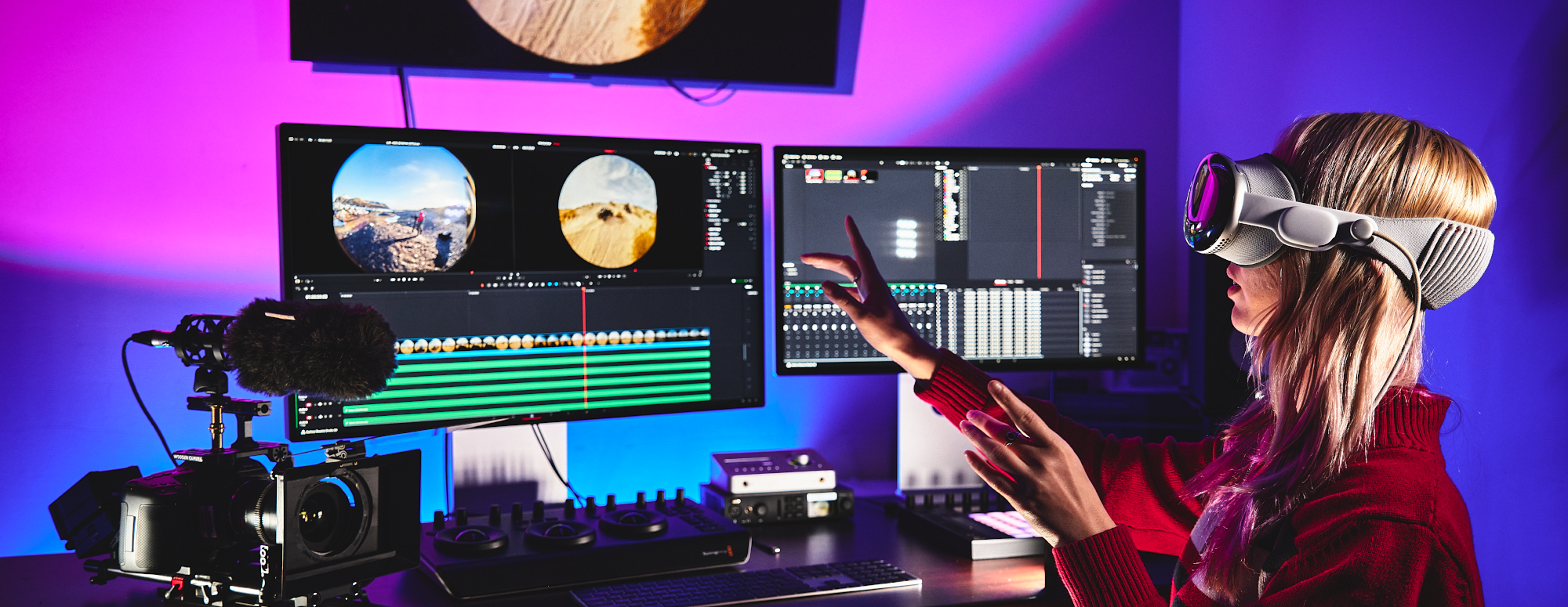 student around a work table with computer and media equipment