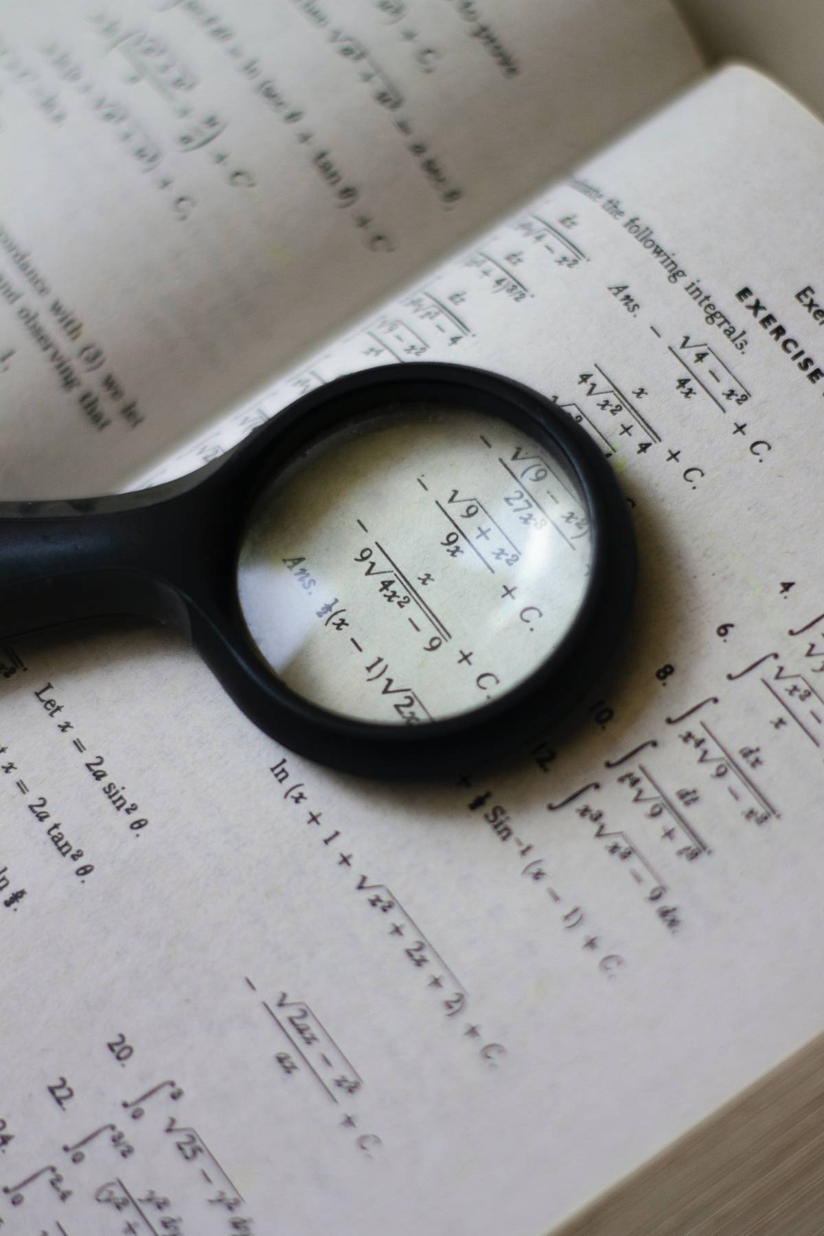math book and magnifying glass