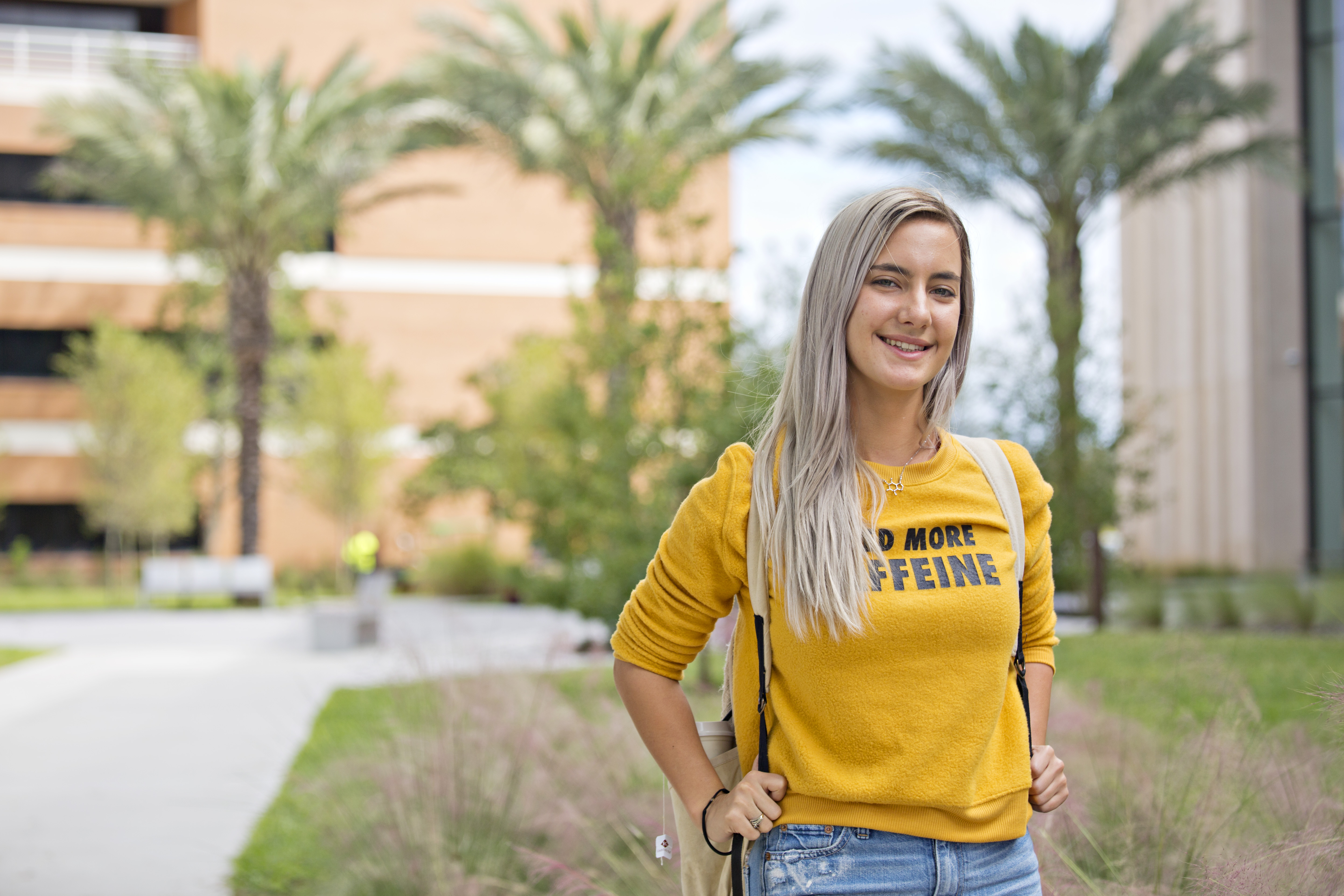 female student in yellow shirt outside