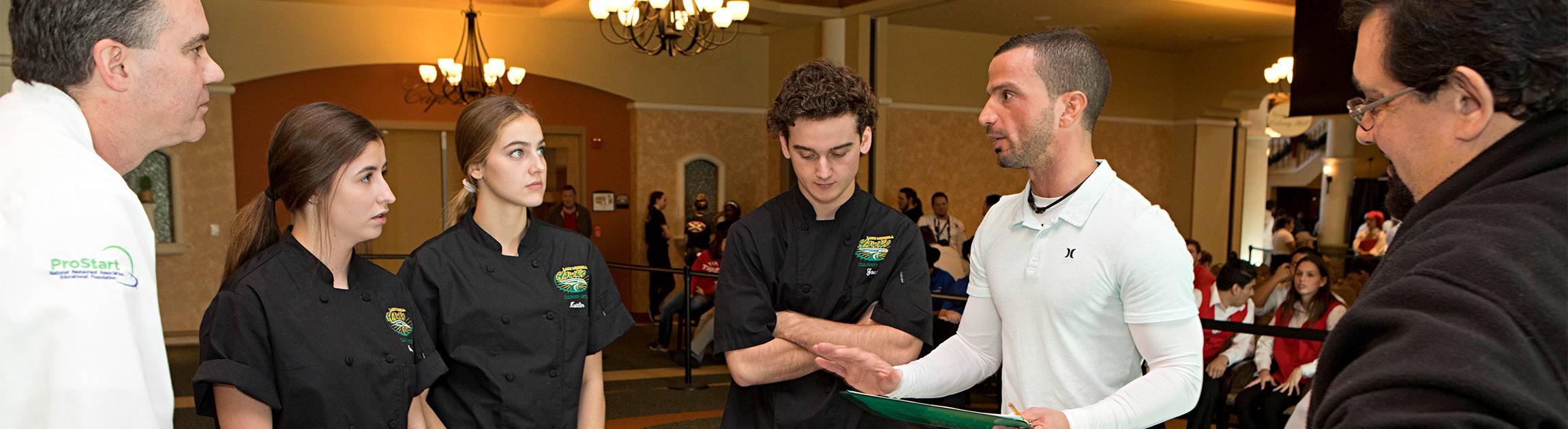 instructor with students at a hospitality event
