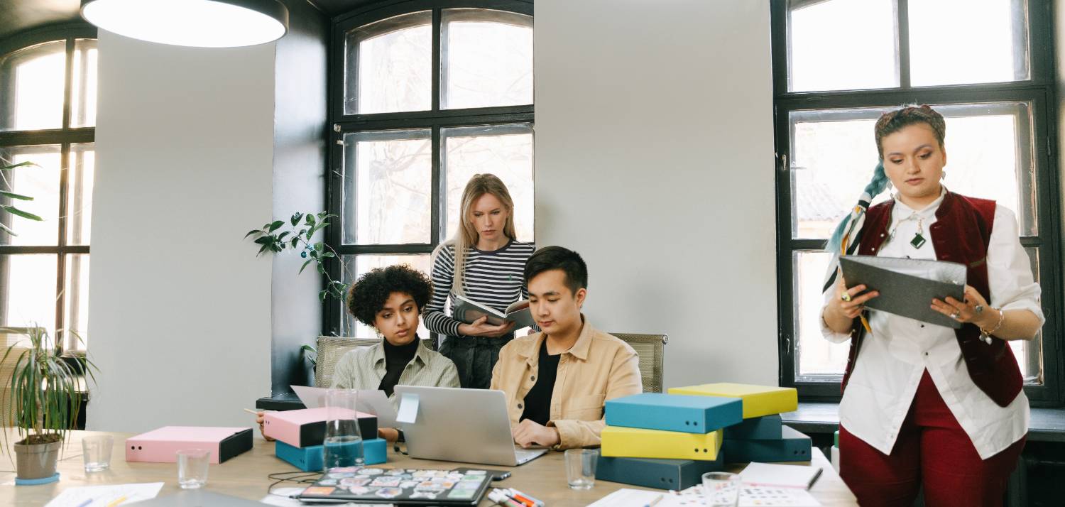 people sitting at a conference table working on a marketing campaign