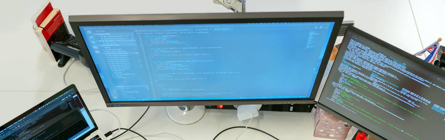 code on multiple computer screens