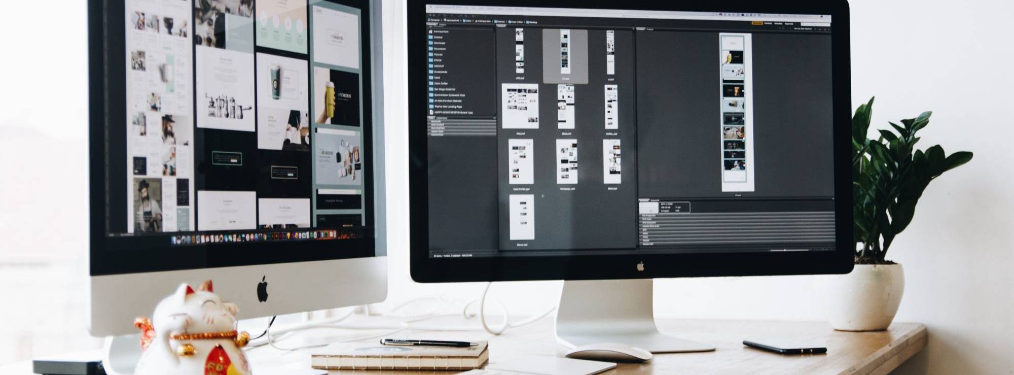 Web development related work on two computer monitors on a desk.