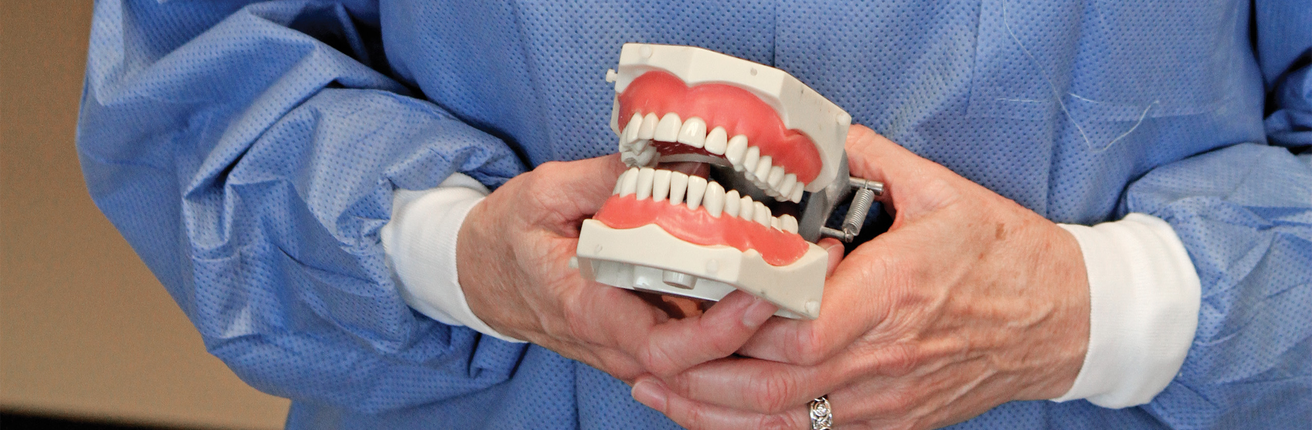 A student holding fake teeth. 