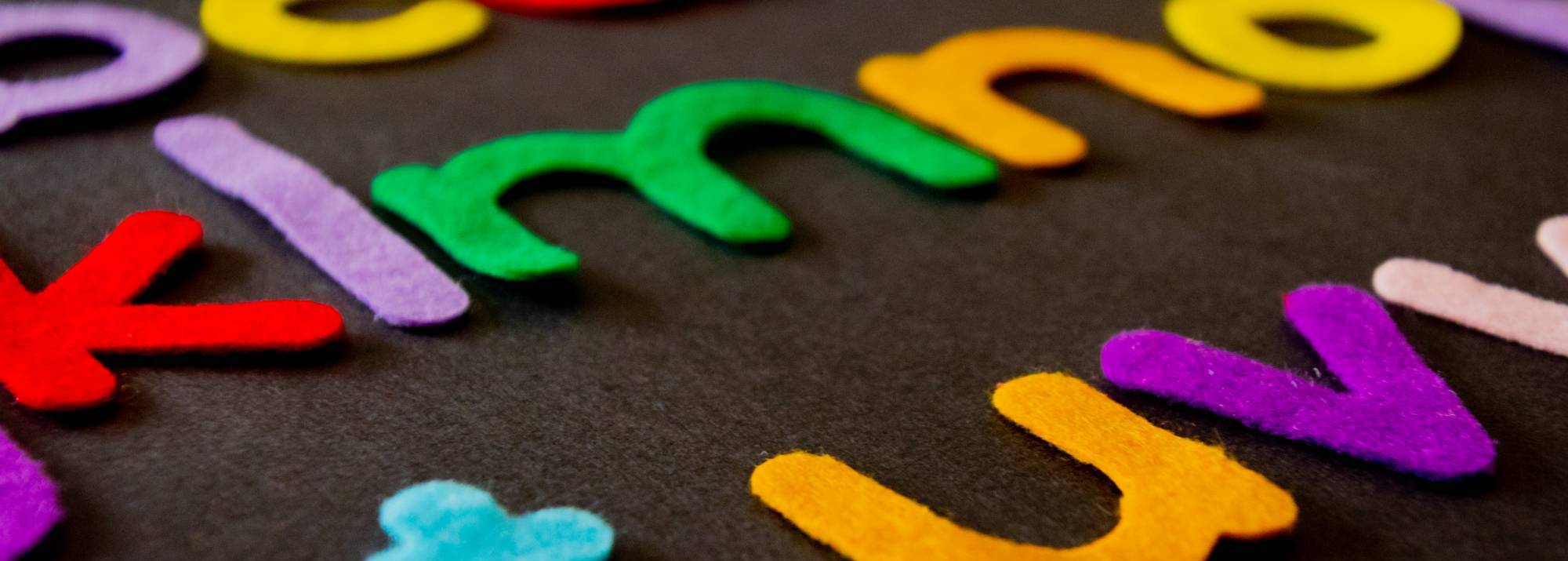 colorful felt letters on a black background