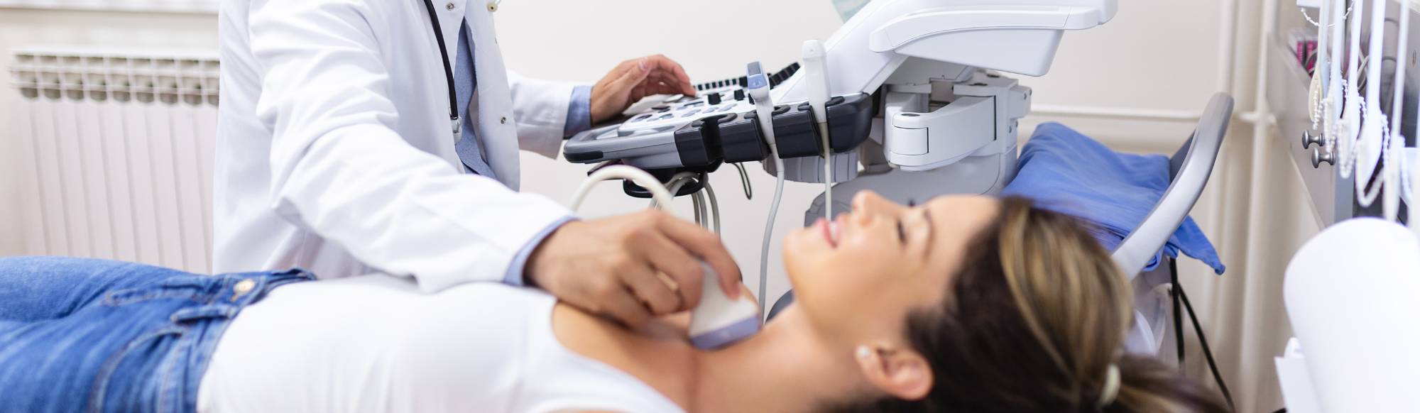 Medical Sonography - Male sonographer checking female patients neck