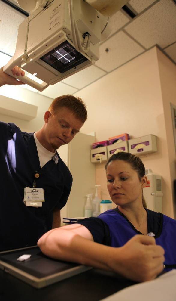 student using x-ray machine on student patient