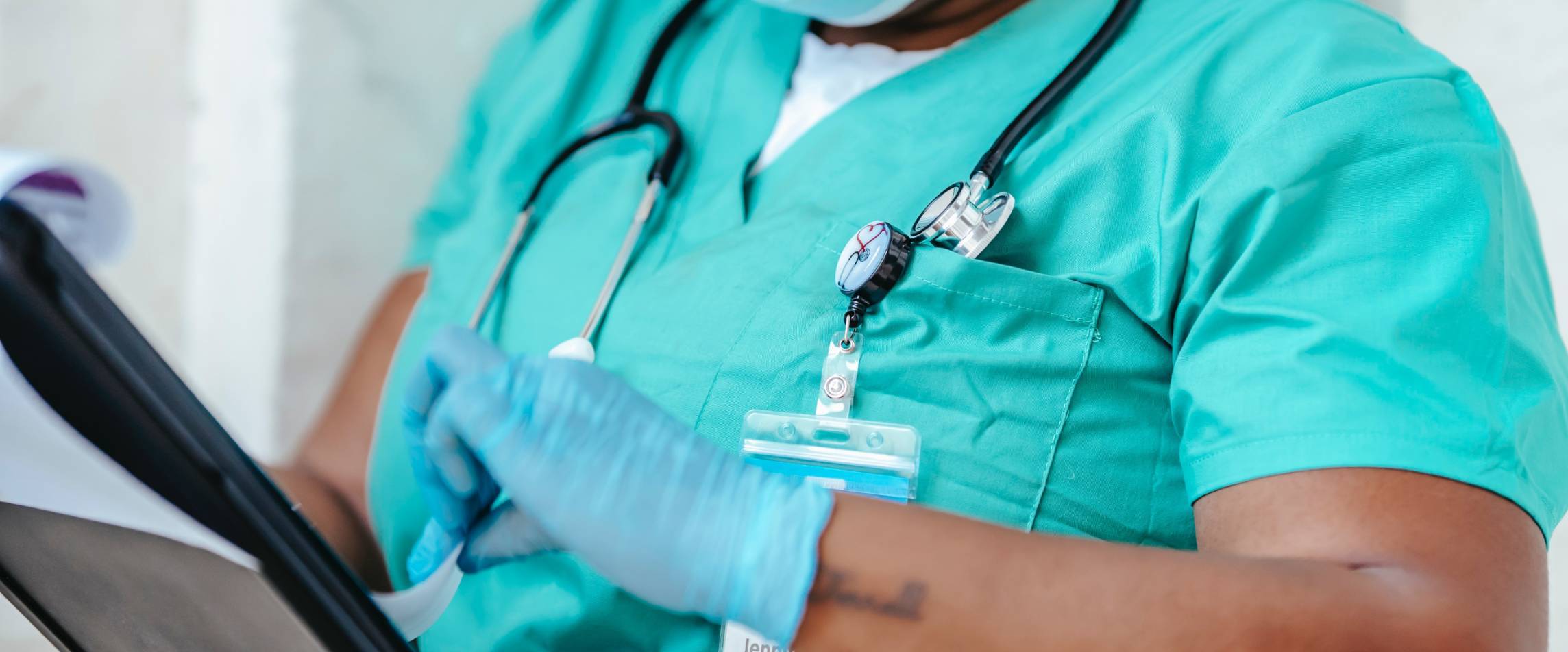 nurse holding a clipboard looking at papers