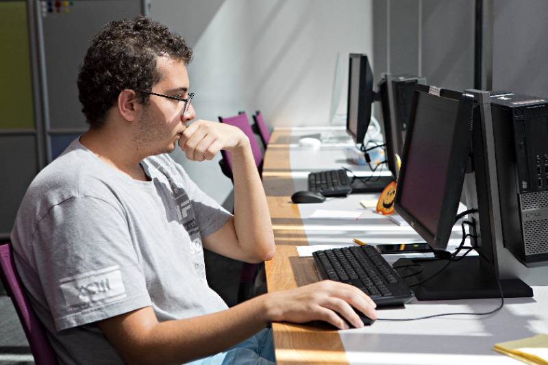 student at a desktop computer