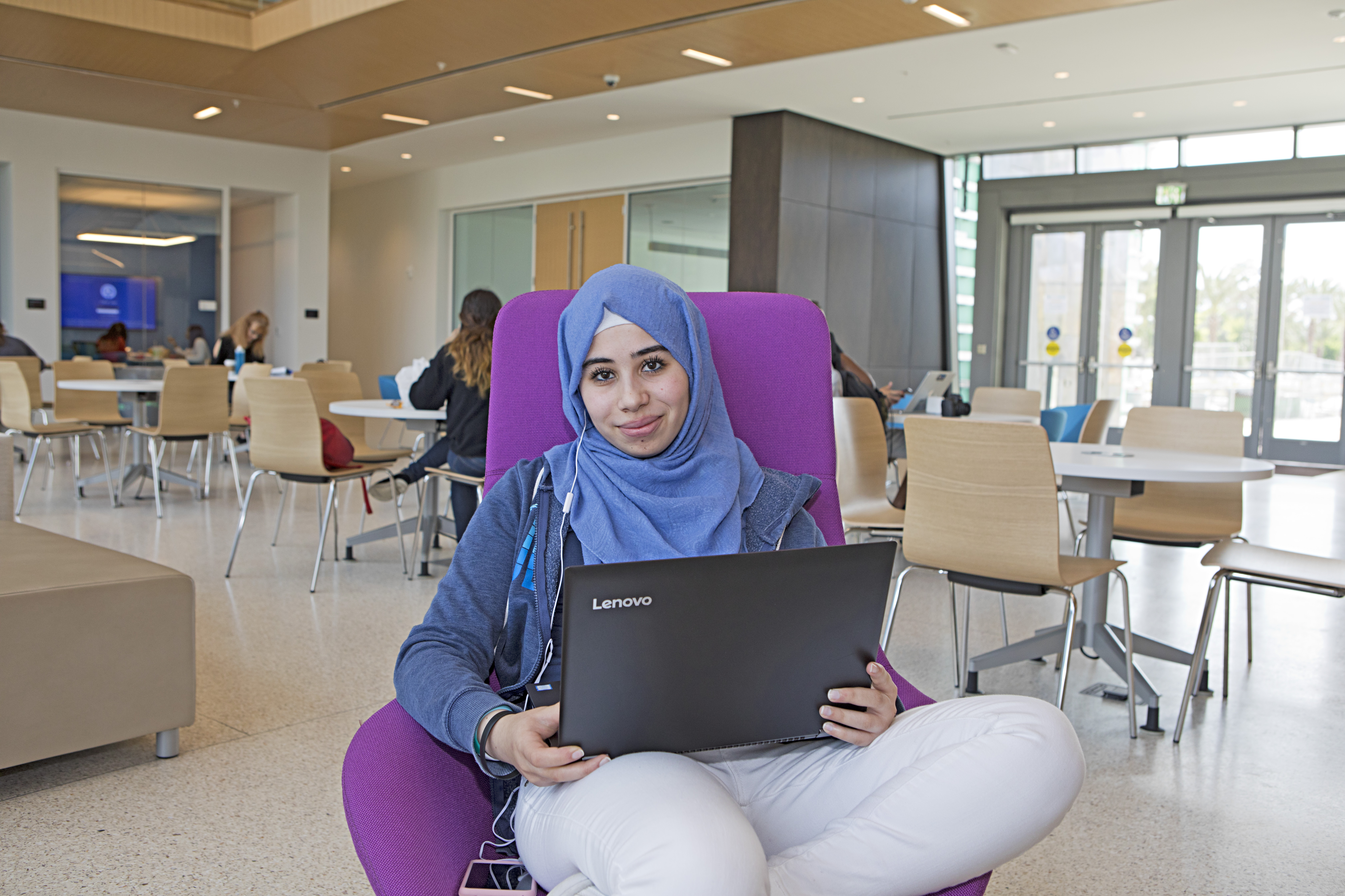 student on laptop in student center