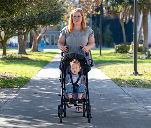 Olive and child in stroller on campus