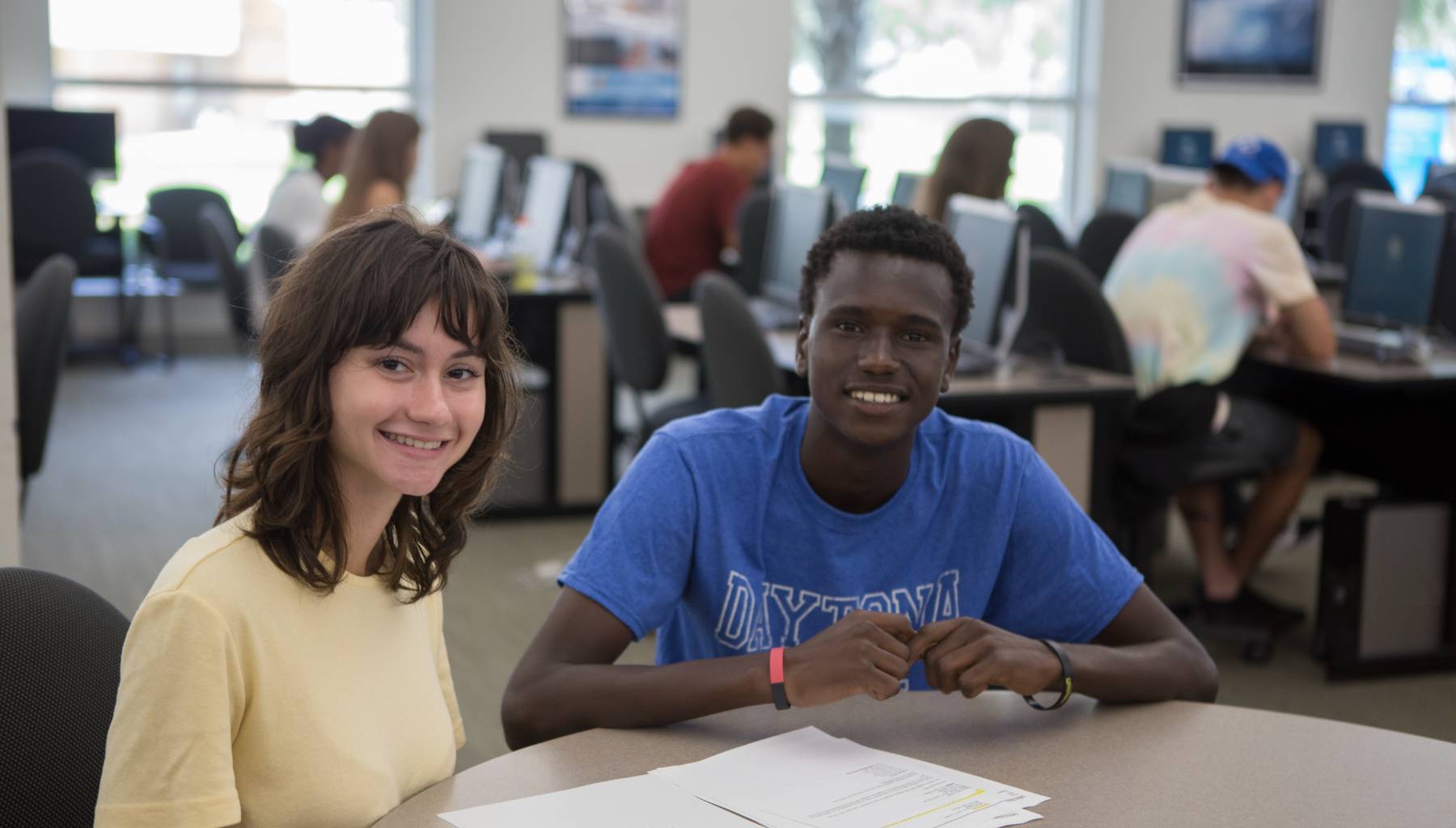 two students at a desk in a computer lab