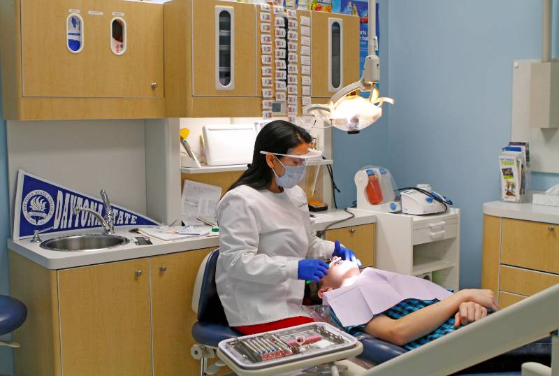 dental hygiene student and patient in clinic