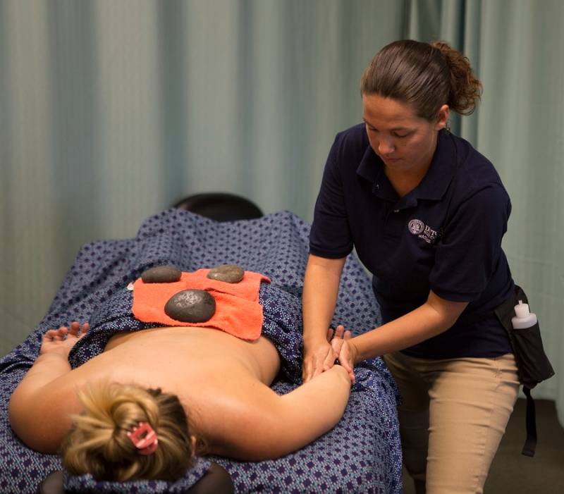massage therapy student and client in clinic