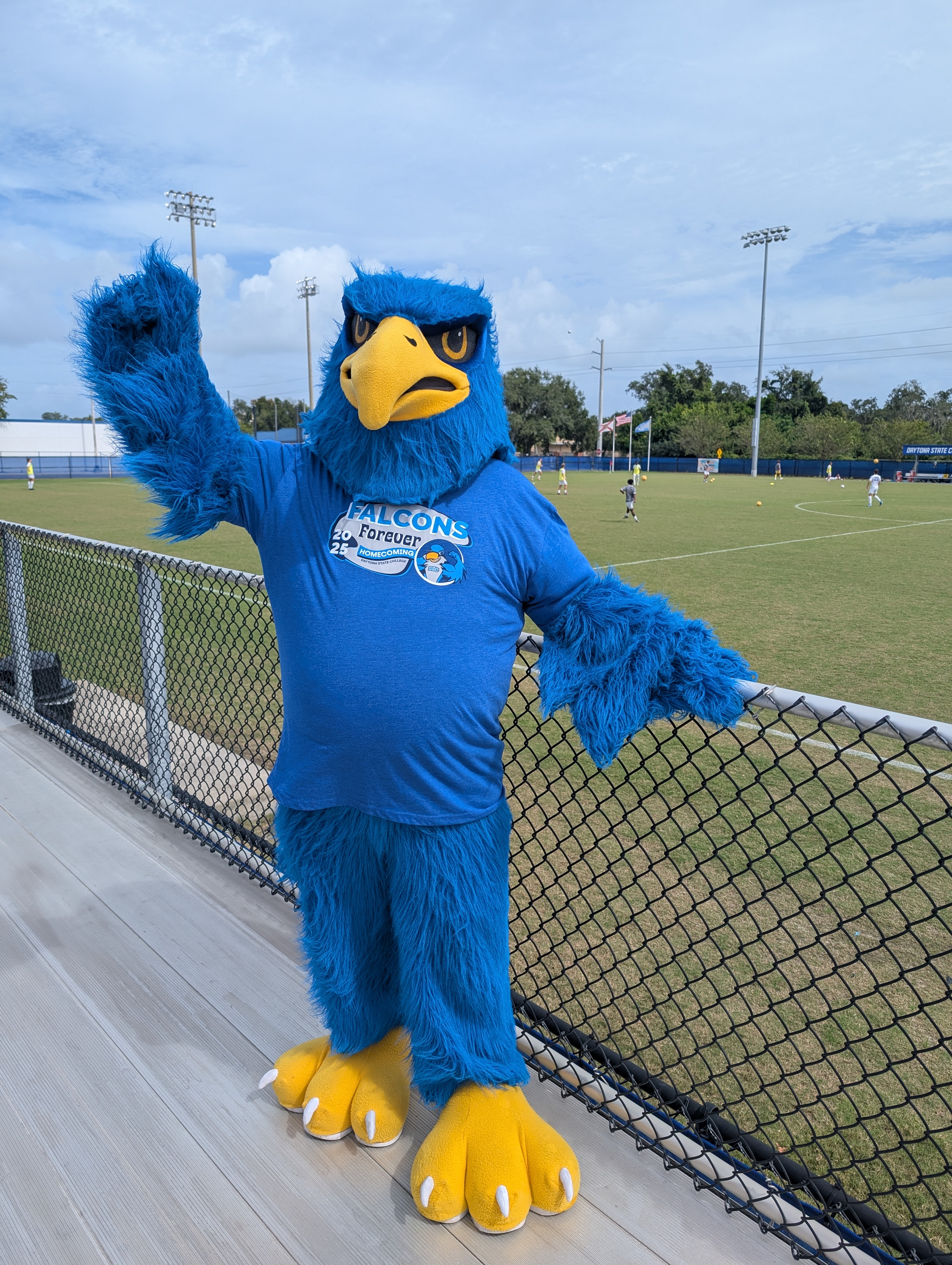A student holding a small pumpkin at the Fall Fest. 