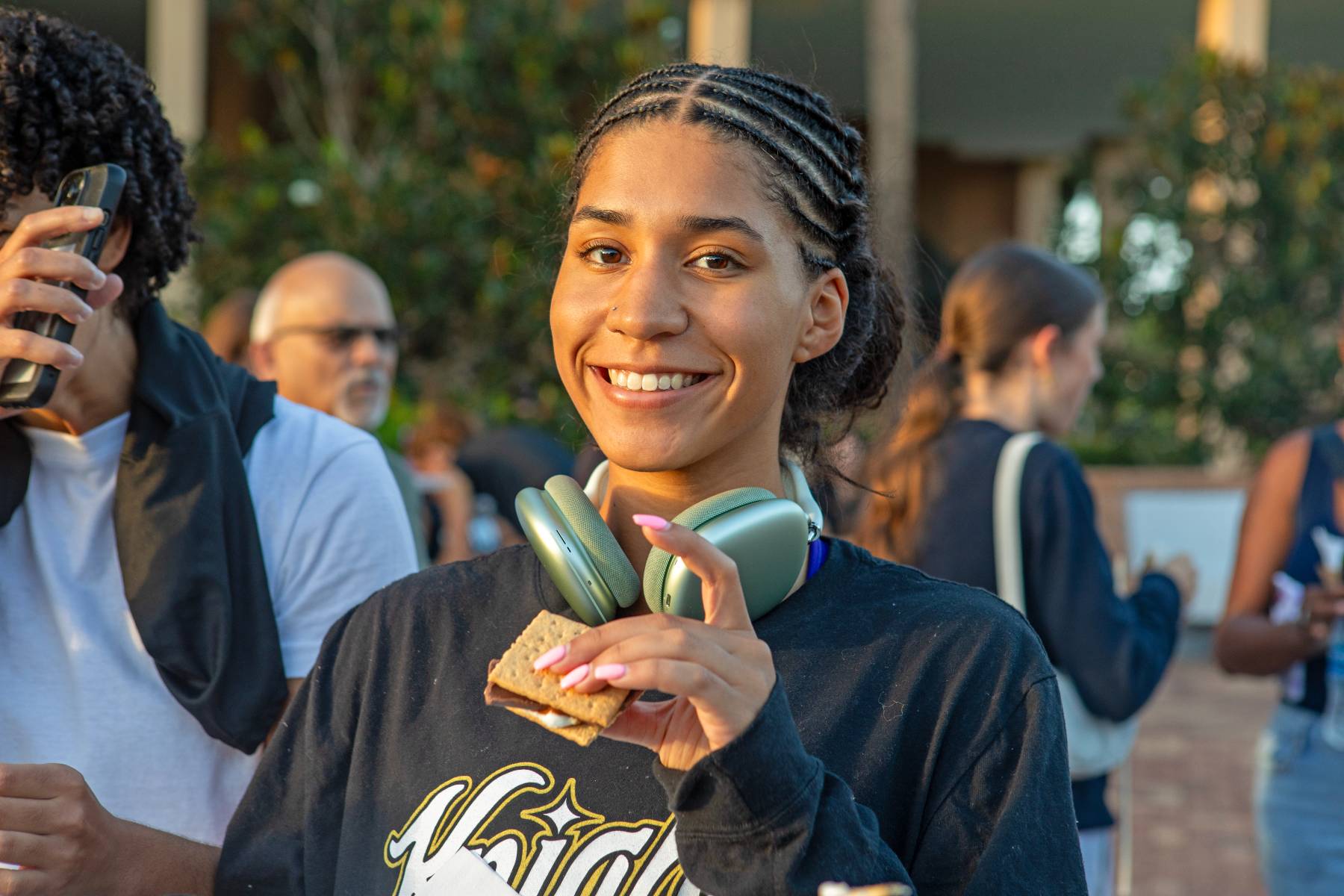 A student enjoys making smores during Homecoming. 
