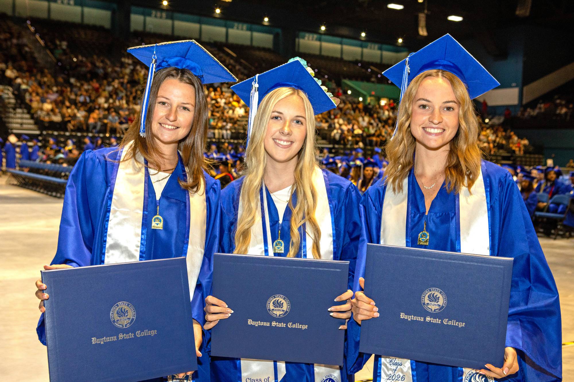 Two students decorate their caps for graduation. 