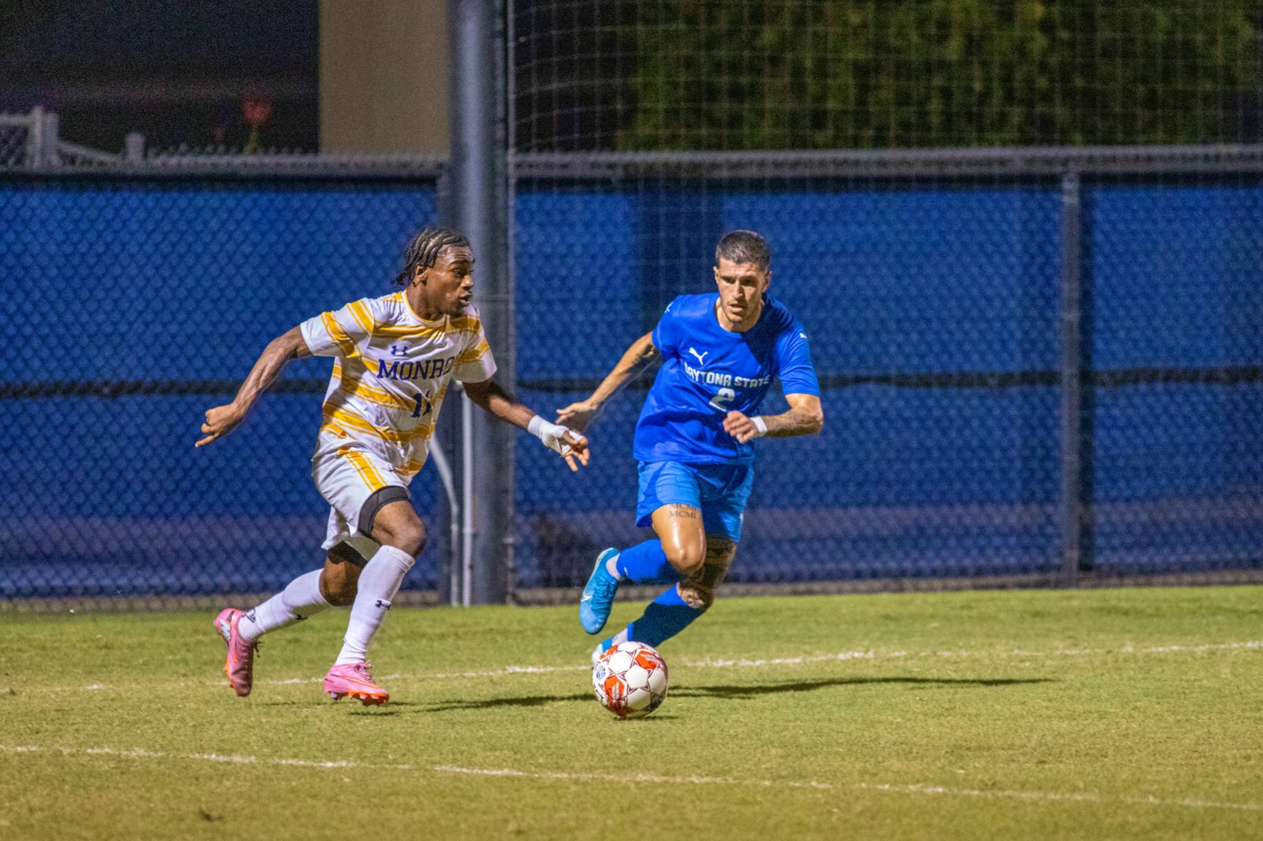 A Falcon soccer player kicking the ball. 