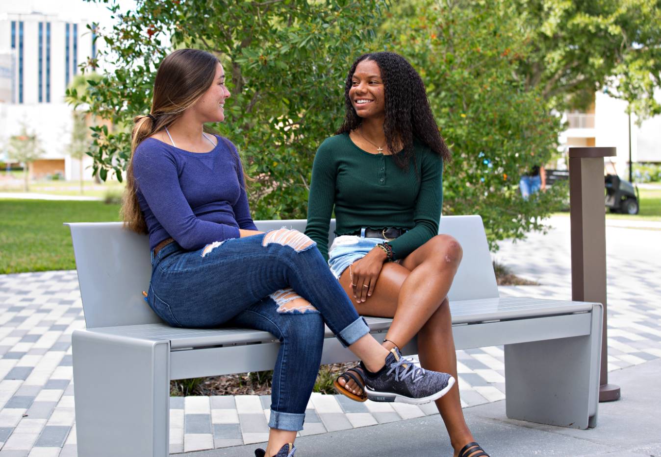 Two students in front of the student center. 