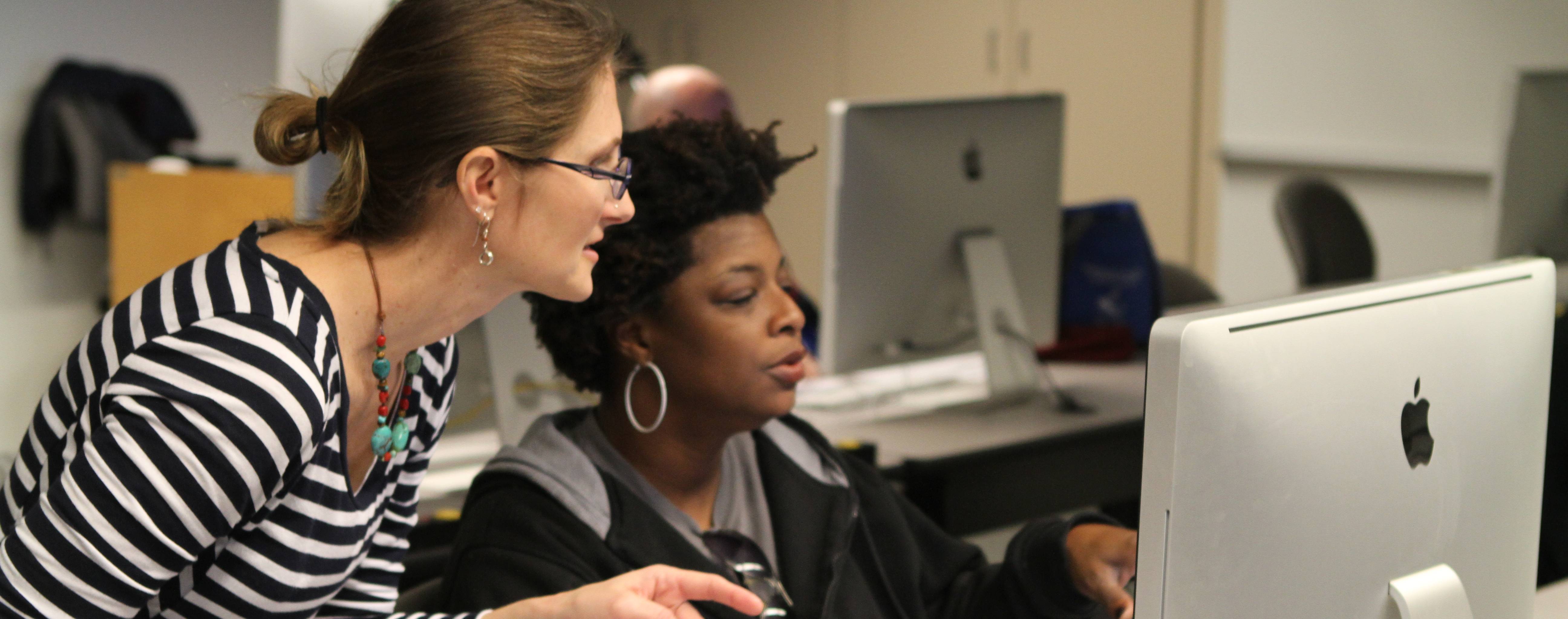 employee with student at computer