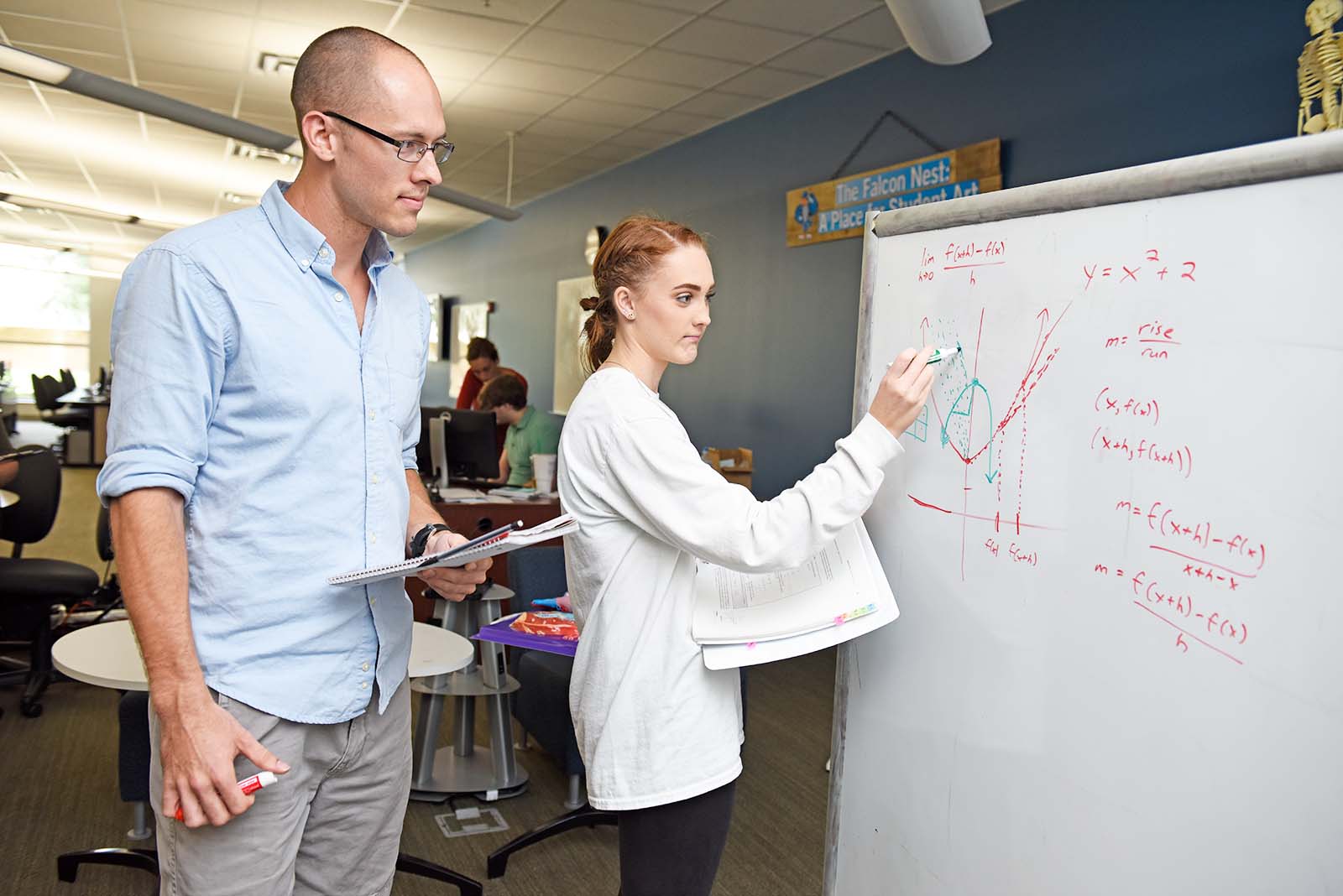 student American Sign Language tutor at a desk