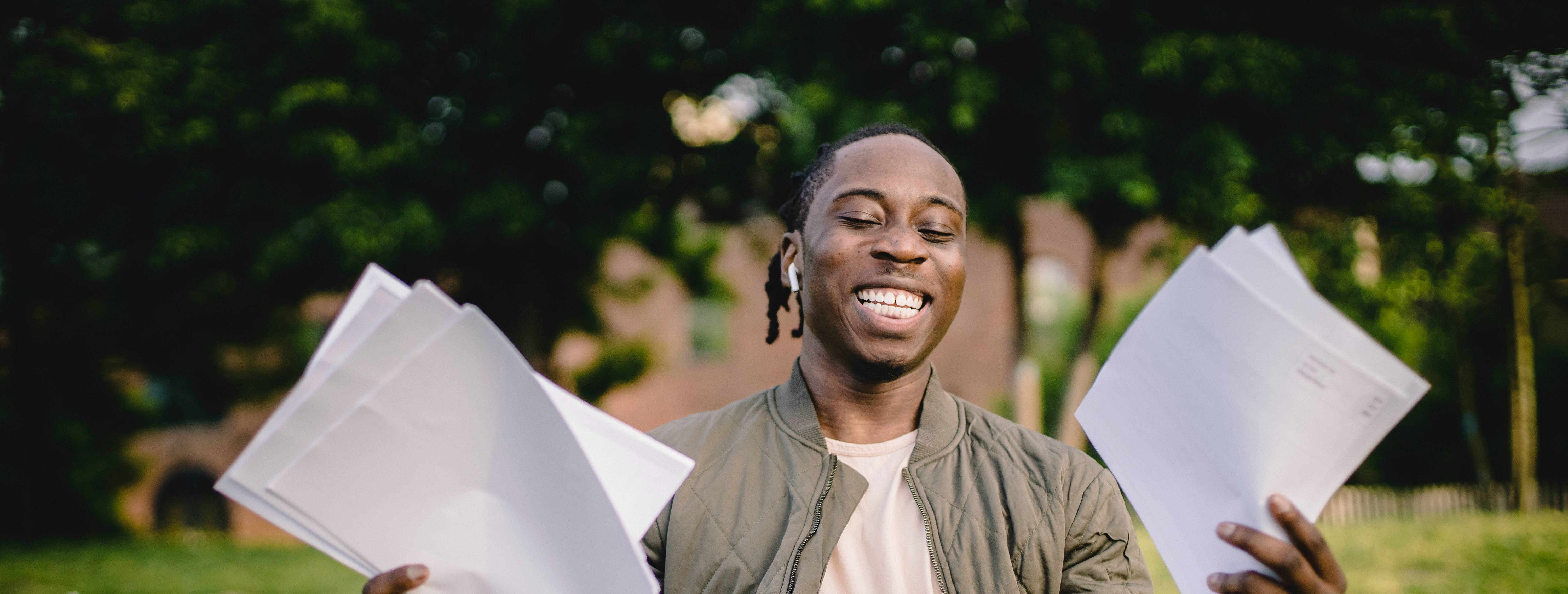 happy student with documents