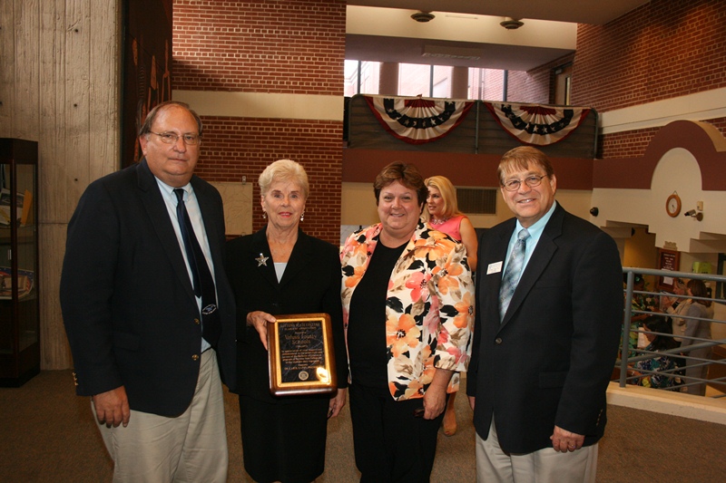 Superintendent of Schools Margaret Smith (left) and School Board President Diane Smith accepted the plaque from Vitale and Potter (left).