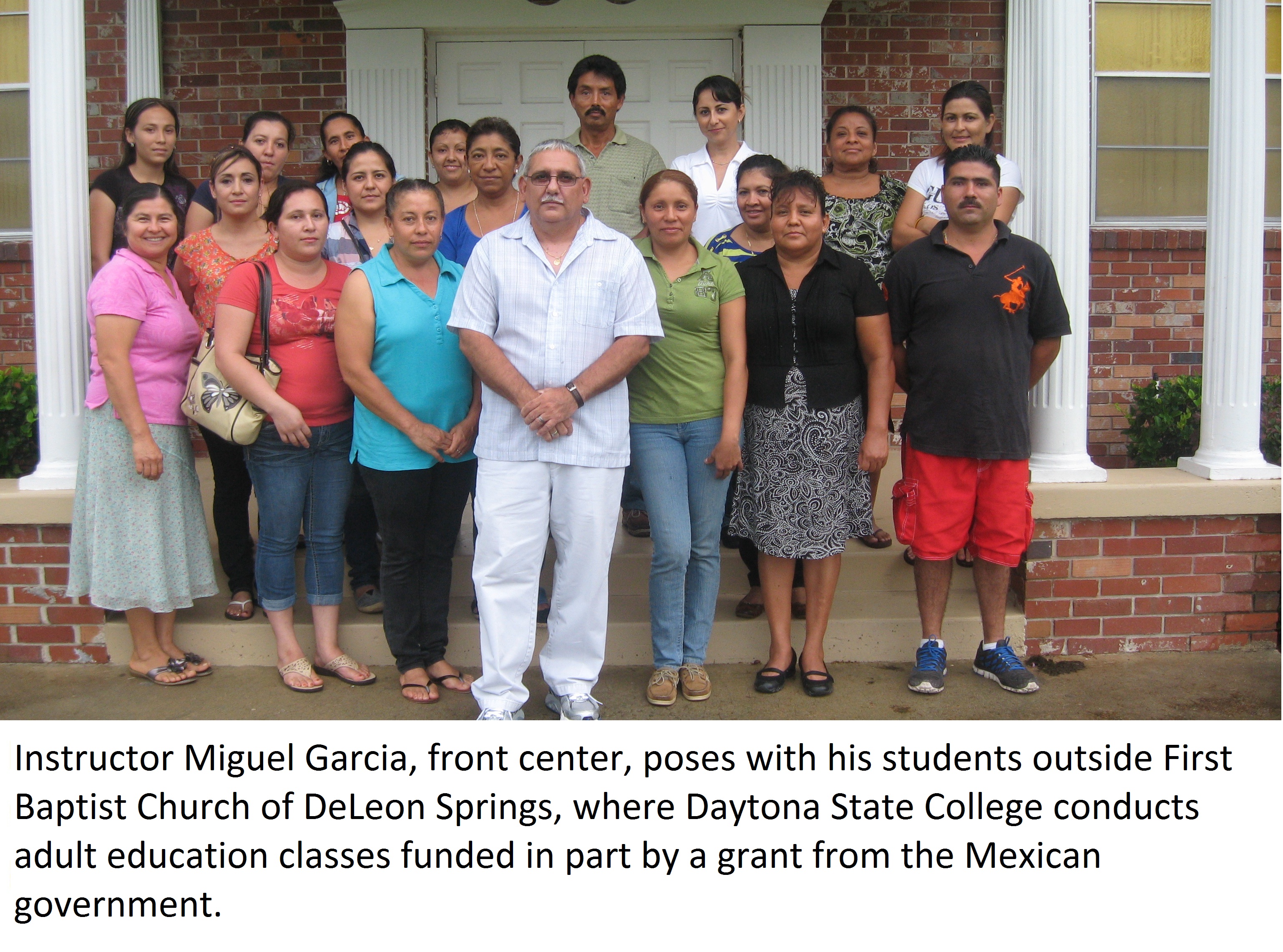 Instructor Miguel Garcia, front center, poses with his students outside First Baptist Church of DeLeon Springs, where Daytona State College conducts adult education classes funded in part by a grant from the Mexican government.
