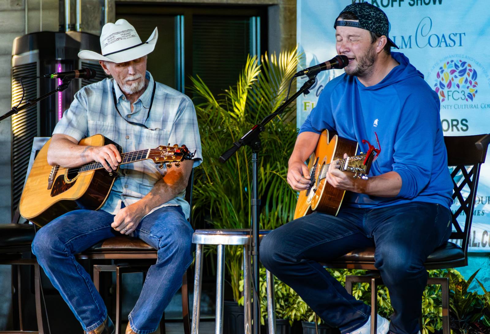 Musicians playing onstage at the Palm Coast Songwriters Festival.