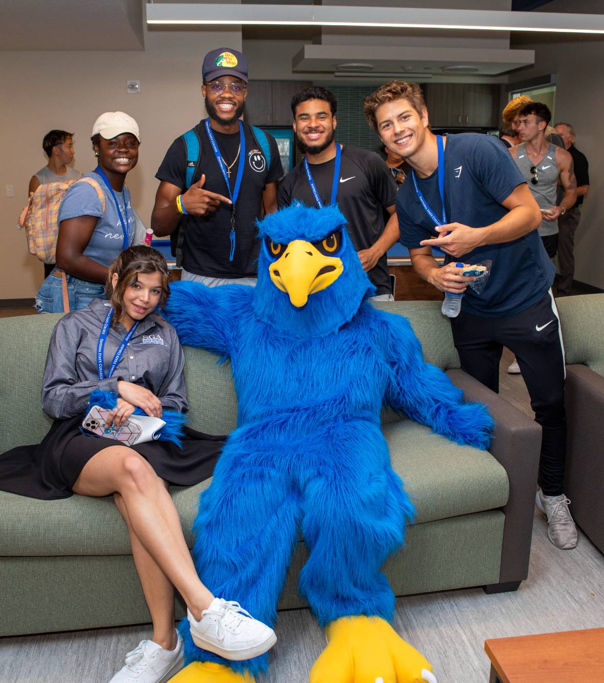 Students and Freddie Falcon in the residence hall lounge. 