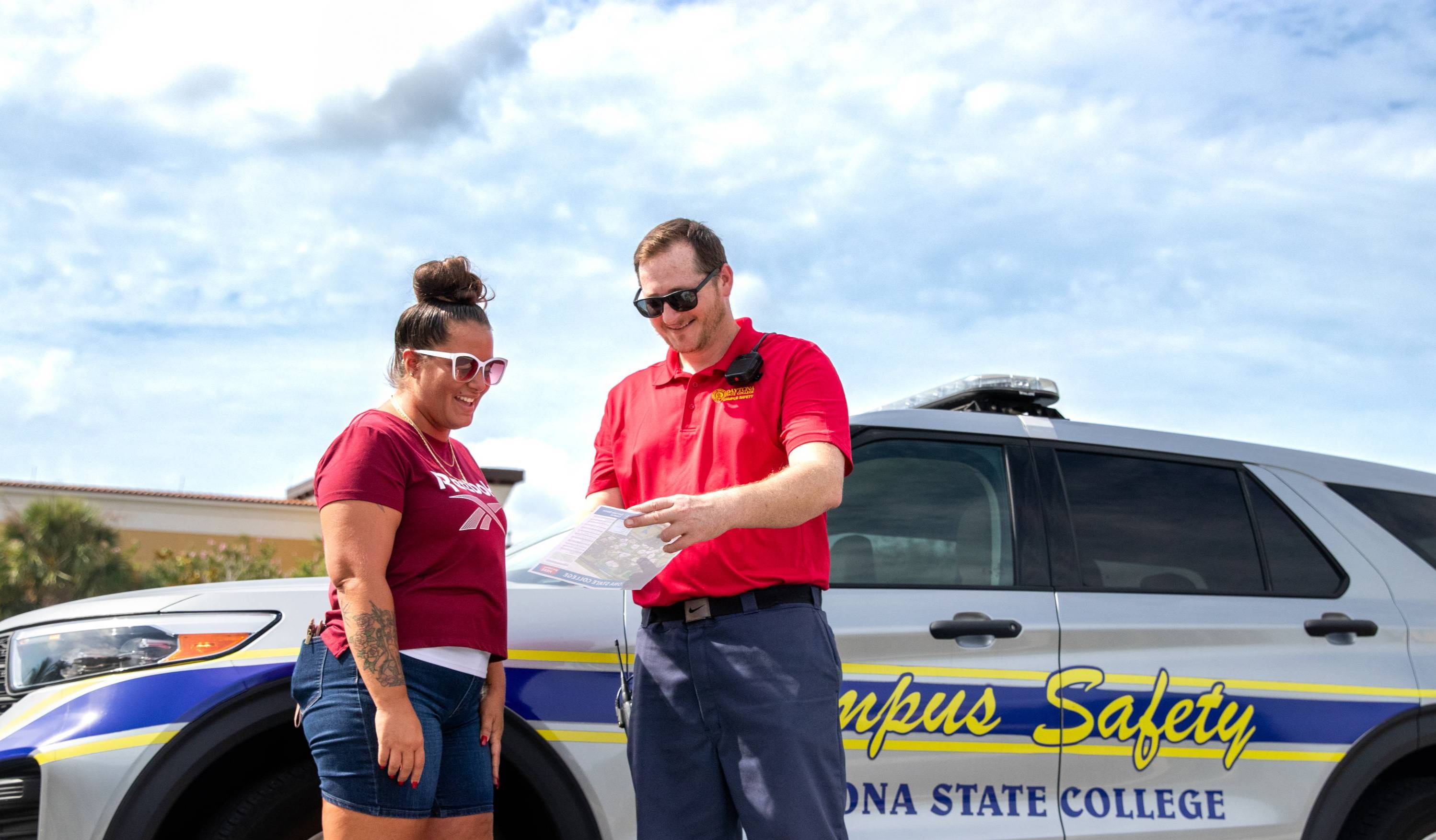 Campus Safety officer helping a student with directions on campus. 