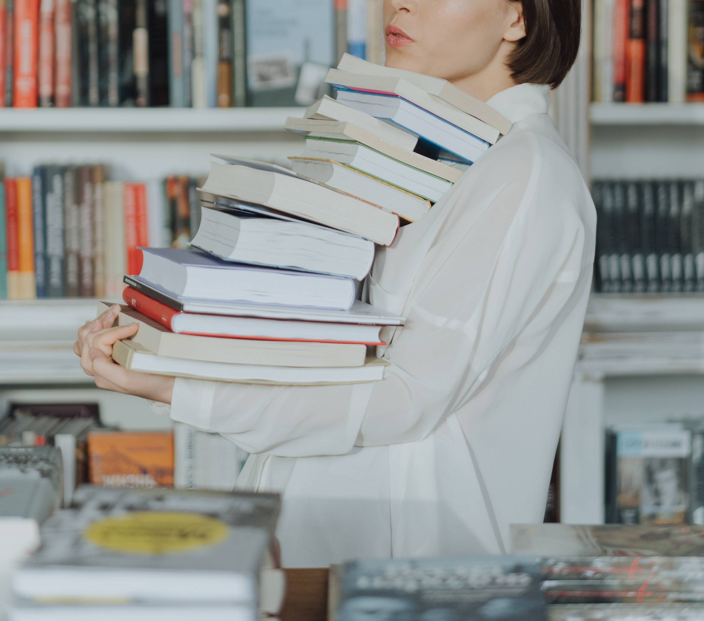 person holding a stack of books