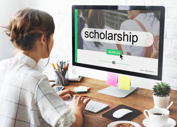 person applying for scholarship on computer