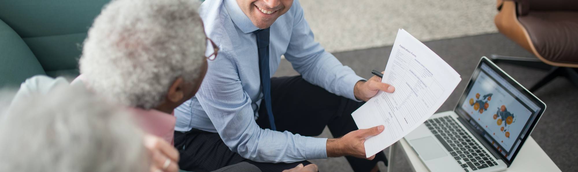 accountant with a couple on a couch reviewing documents