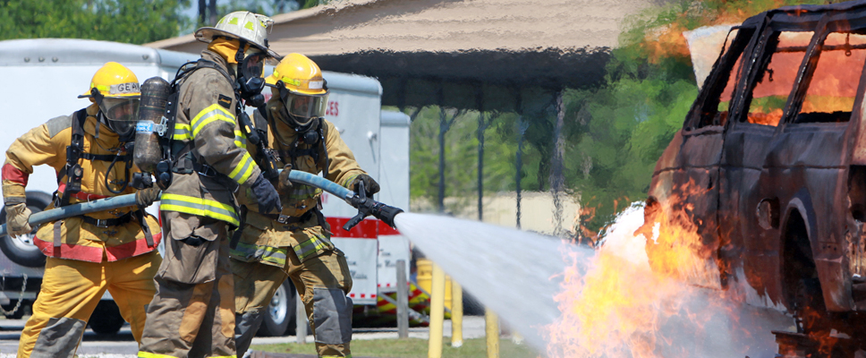 Fire fighters fighting a car on fire