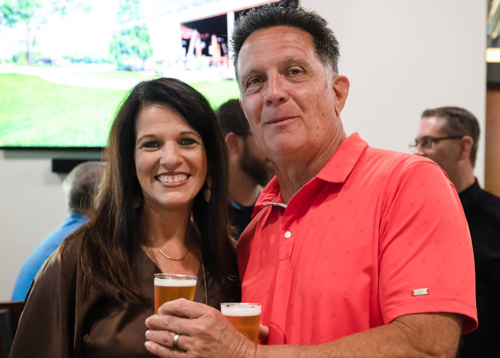 Two guests enjoying beer at the event.