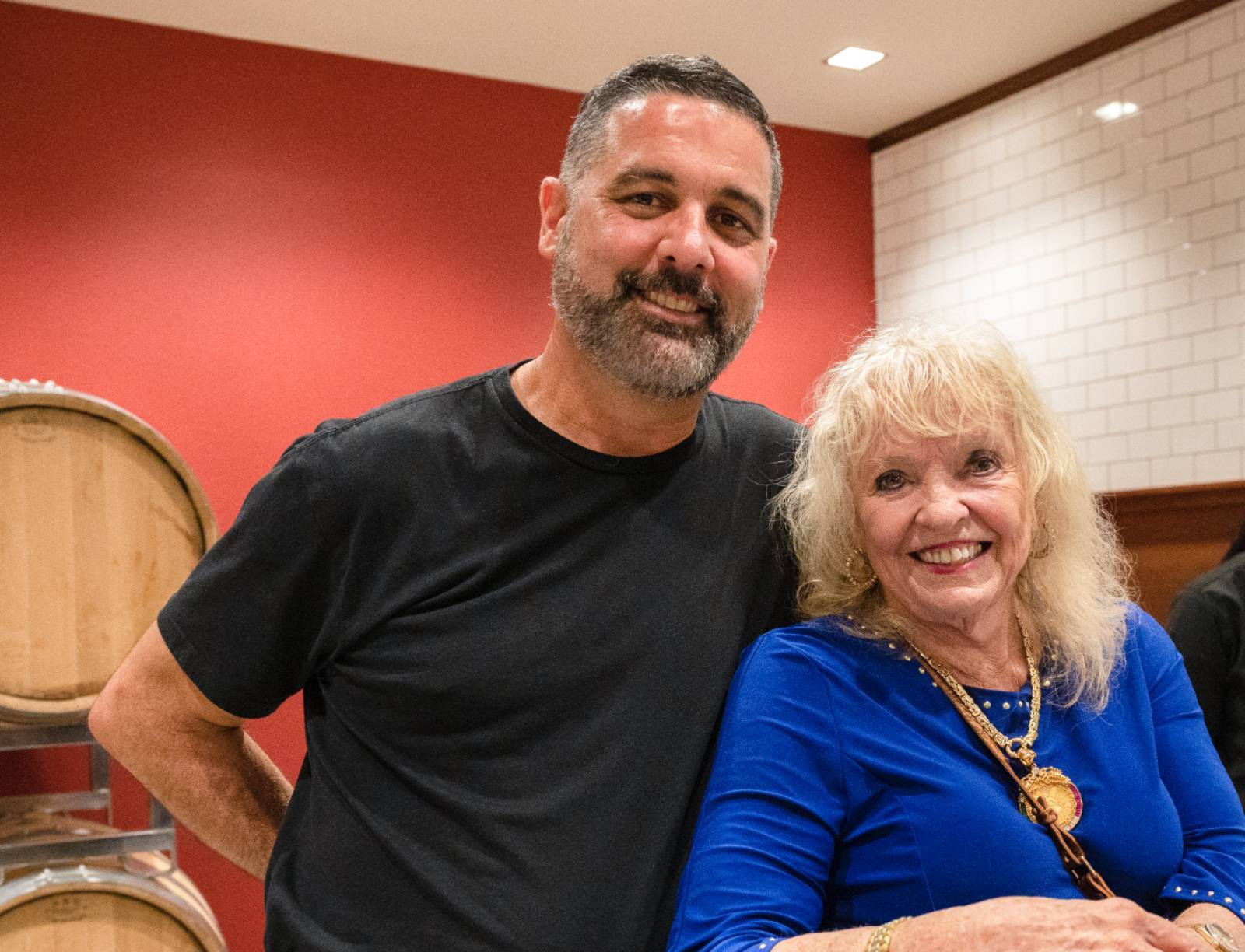 Two smiling guests at the bar.