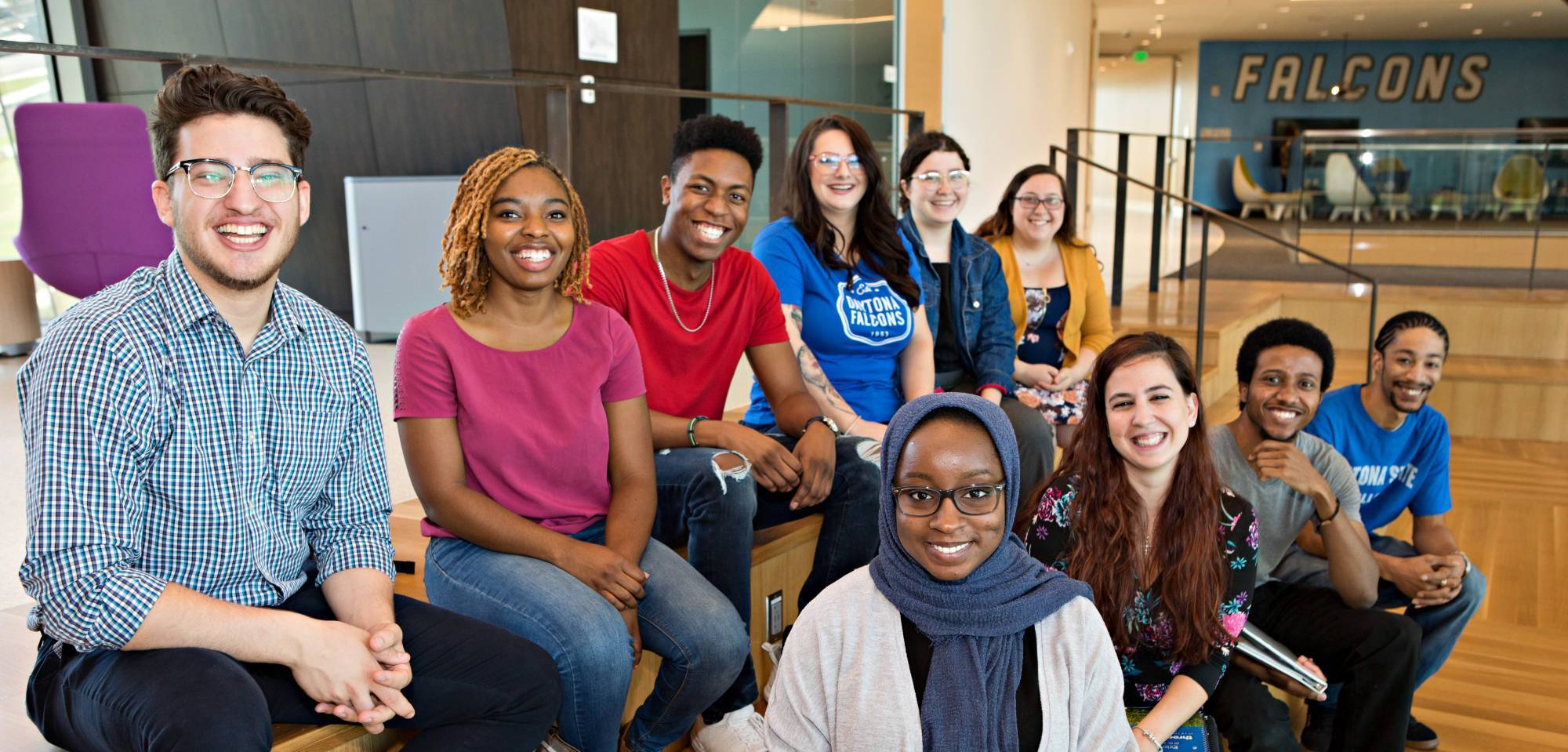 students smiling while sitting in the student center