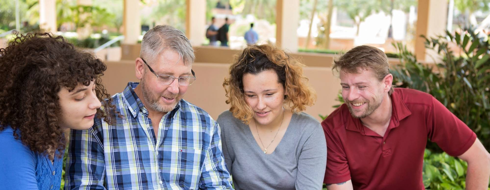 a family outside reviewing paperwork