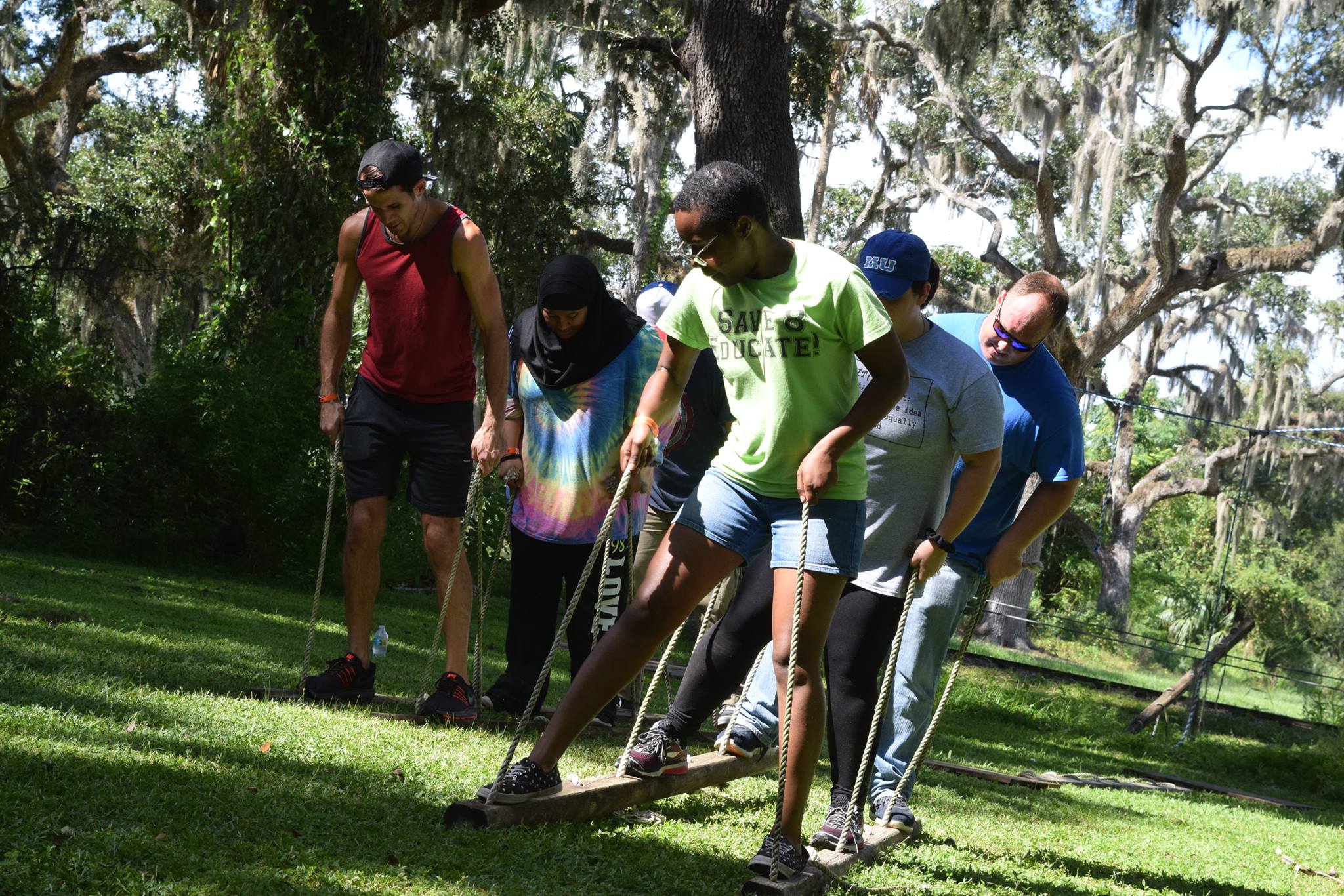 leadership workshop students on wooden stilts