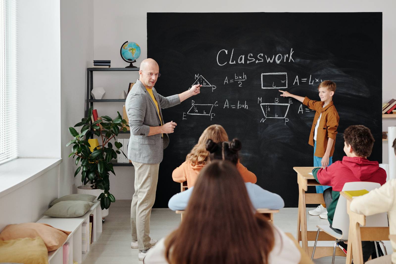 teacher in front of classroom full of students