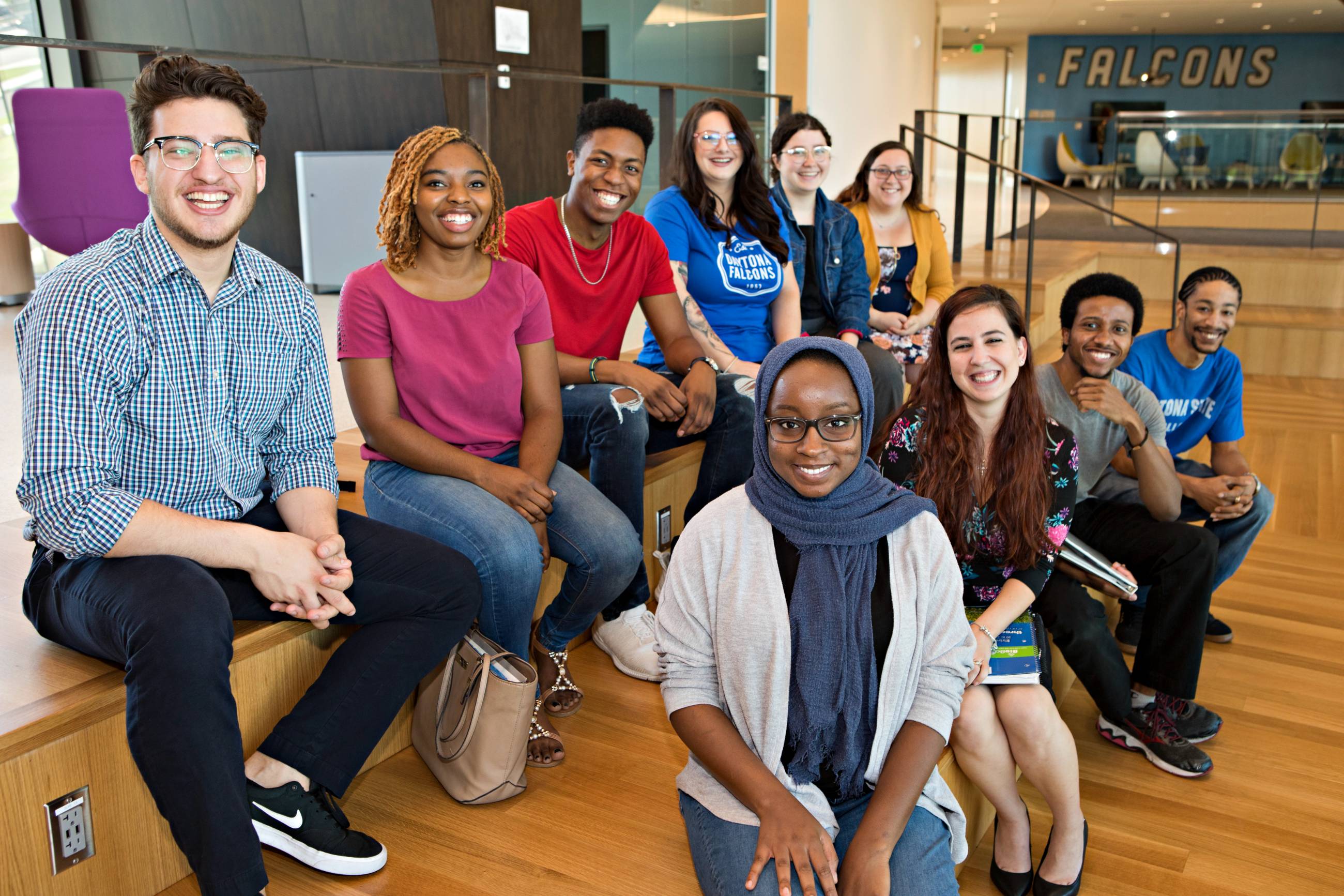 group of diverse students sitting together smiling